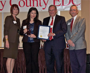 Rockwell Labs CEO Dr. Cisse Spragins, second from left, receives the Keystone Award from the Clay County Economic Development Council.