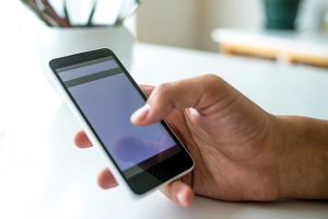 Texting on a smartphone photo from iStock.com/StockRocket