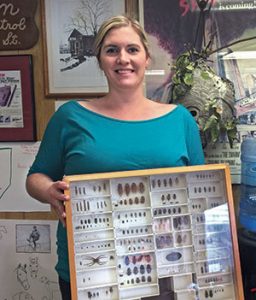 Molly Patton Marsh, who is due with her second child in November, shows one of several insect identification drawers on hand at Patton Pest Control’s headquarters. Photo: Heather Gooch