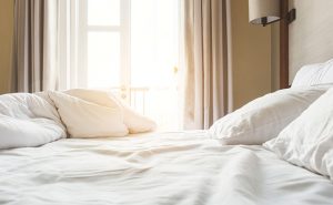 hotel bed photo from iStock.com/TeerawatWinyarat