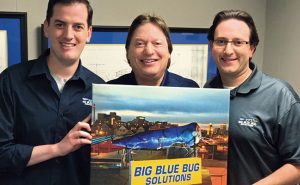 From left, Big Blue Solutions’ Brian, Stephan and Scott Goldman show off the iconic termite that appears to have landed on top of the company’s Providence, R.I., building.Photo: Ray Johnson