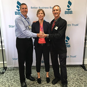 President and CEO Mickey Nolen, right, accepts the BBB Torch Award for Ethics. PHOTO: NOZZLE NOLEN PEST SOLUTIONS
