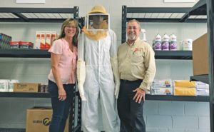 Office Manager Laura Lentz and Supervisor George Cochran stand with a Schopen Pest Solutions retail display. PHOTO: PETE SCHOPEN