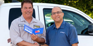 Rob Guyette is congratulated by Liphatech Northeast USA District Sales Manager Barry Pitkoff. PHOTO: LIPHATECH