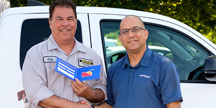 Rob Guyette is congratulated by Liphatech Northeast USA District Sales Manager Barry Pitkoff. PHOTO: LIPHATECH