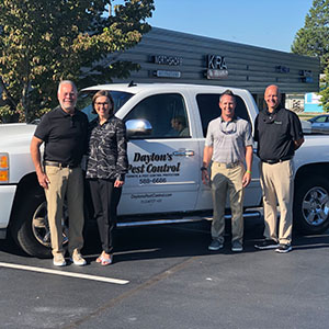 From left are Dayton and Sheila Hylton, Waynes President Eric Frye, and Shawn Hollis of Waynes. PHOTO: WAYNES PEST CONTROL