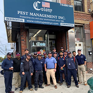Some of the Colony Pest Management team wearing pink-trimmed hats for breast cancer awareness outside of the Brooklyn, New York, office. PHOTO: COLONY PEST MANAGEMENT