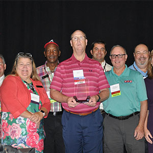 Dan Hill (middle) displays his Wayne Webber Award of Excellence among CPCO of GA board members, directors and staff. From left: Ron Combs, Marty Jones, Cindy Jones, Charles Chambers, Dan Hill, Matt Clark, Paul Bello, Jeff Swaney, Glenda Lehmberg and Maria Collins. PHOTO: CPCO OF GA
