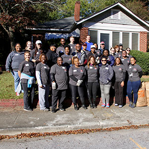 Rollins employees gather for a picture in the Grove Park community after completing their day of service. PHOTO: ROLLINS