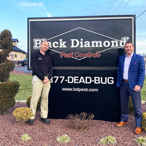 From left, New Elizabethtown Branch Manager Eric Freedland poses with Black Diamond Pest Control CEO Keith Duncan, Jr. in front of the Black Diamond sign. PHOTO: BLACK DIAMOND PEST CONTROL