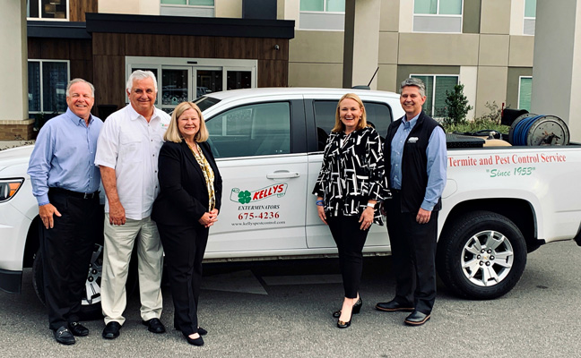 From left are Arrow Exterminators' Kevin Burns, Emily Thomas Kendrick and Tim Pollard, stand with Tommy and Neci Kelly of Kelly's Pest Control, in the middle. PHOTO: ARROW EXTERMINATORS