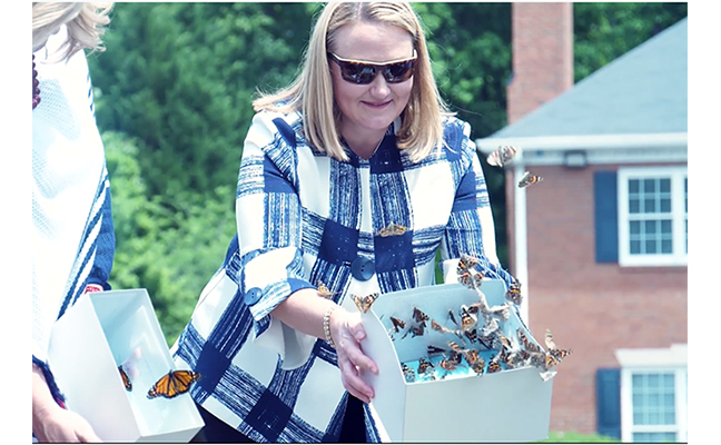 Arrow President and CEO Emily Thomas Kendrick helps release butterflies in a video for Mother's Day. IMAGE: ARROW EXTERMINATORS