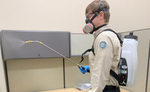 Versacor Total Quality Manager Ryan Gates performs the disinfection service at an office account. PHOTO: VERSACOR ENTERPRISES