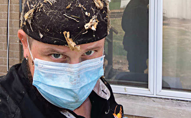 Schopen Pest Solutions’ Observational Biologist Mark Berry proudly emerges from a crawlspace in Wood Dale, Ill., after an inspection. PHOTO: SCHOPEN PEST SOLUTIONS