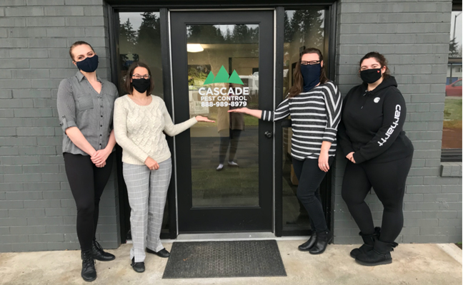 Cascade Pest Control employees at the entrance of the new office. From left are: Bailey Luder, Amy Houston, Brittney Knauts, Kristin Miller. PHOTO: LORA PETERSON, CASCADE PEST CONTROL