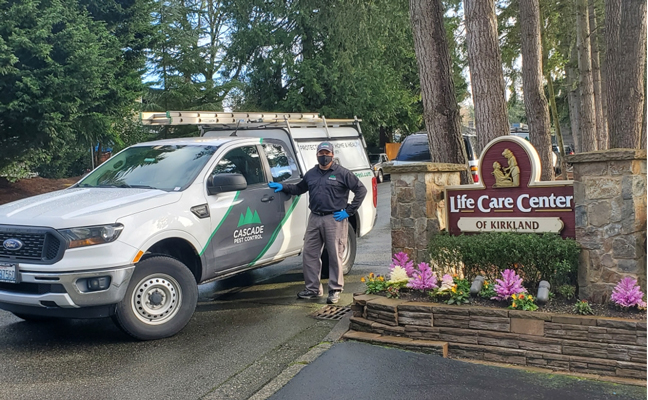 Gil Flores, a technician at Cascade Pest Control, stands in front of the residential care facility in Kirkland, Wash., where the COVID-19 pandemic first appeared in the U.S. PHOTO: ALEAH TREFTZ, CASCADE PEST CONTROL