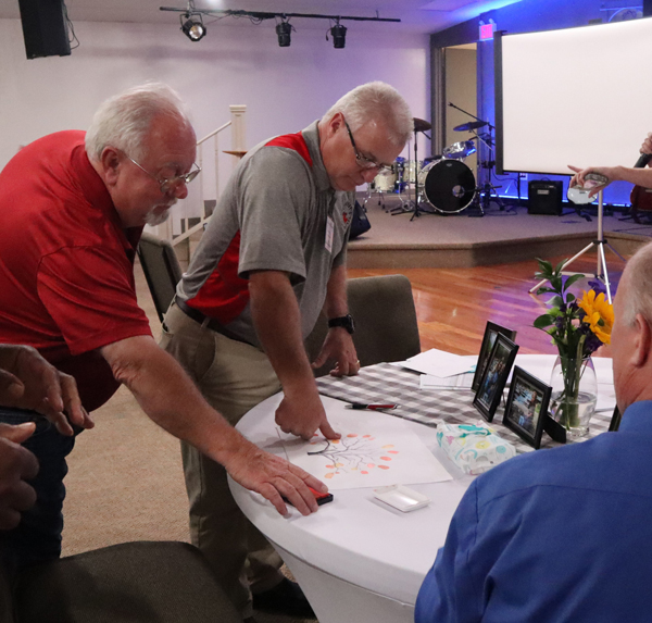 Pest management professionals attending the CPCO of GA Savannah Spring Seminar in April contribute to thumbprint artwork for the Jordan family. PHOTO: P.E.S.T. Relief International