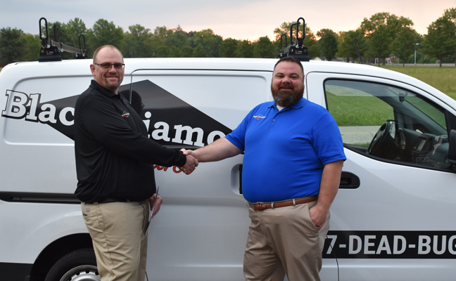 Director of Business Expansion Travis Donaldson (right) congratulates Branch Operations Manager Brian Thornton (left) on opening Black Diamond's newest branch location in Knoxville. PHOTO: BLACK DIAMOND PEST CONTROL