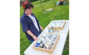 Bug Bowl intern Sydney Territo shows some of her favorite bugs to Girl Scouts at Spark Day 2024. (Photo courtesy of Franklin Pest Solutions)