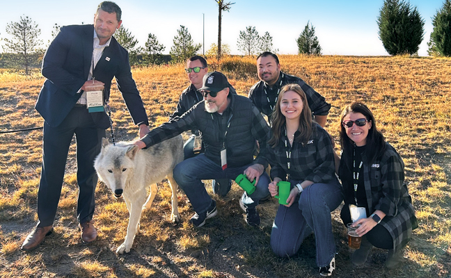 Who let the wolves out: A (professionally trained) wolf enjoys some attention from MGK team members. PHOTO: MGK