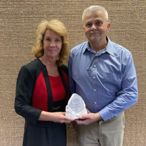 Bobby Lane, Jr. , president of the East Tennessee Pest Control Association awarded the ETPCA Hall of Fame award to Marie Horner, vice president of government affairs for Arrow Exterminators. PHOTO COURTESY OF ETPCA