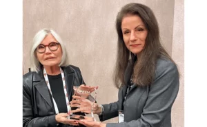 Karen Furgiuele, left, was presented with the award by Dr. Cisse Spragins, then-UPFDA president, right. PHOTO: UPFDA