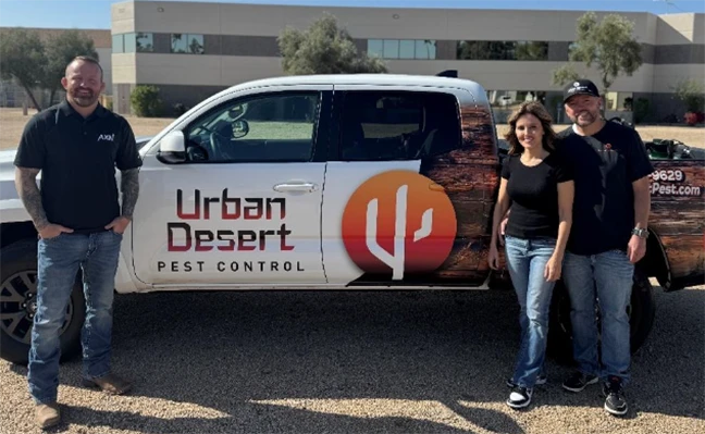 Members of each company pose in front of a company-branded truck to celebrate the partnership.