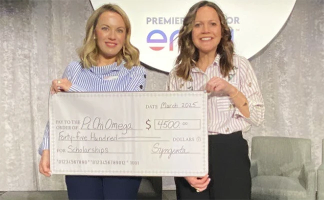 Dr. Cassie Krejci, BCE accepts Syngenta's scholarship donation from Kristen Oakley, market manager at Syngenta. PHOTO COURTESY OF PI CHI OMEGA