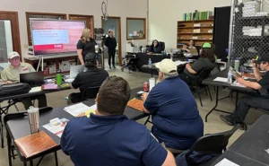 Training meeting action shot with Paul Bello and Adrian Culpepper.
