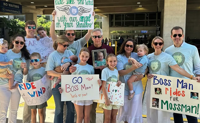 The author, center, holds a photo of Moss Pieratt while
surrounded by family during the Brothers Bike 2025 tour. IMAGE: JENKS FAMILY