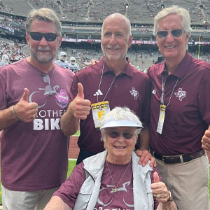 Pictured from left are Dennis, Raleigh and Bobby Jenkins, standing behind their mom, Sandra Jenkins, this summer after a successful "Brothers Bike” charity fundraising tour.