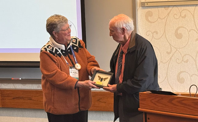 Pi Chi Omega President James Miller, ACE, PCO market manager of Trécé, and former Pi Chi Omega President Dale Baker, president of J.T. Eaton, catch up before the fraternity's luncheon. (Photo texted to RJ for help!) 
 
During the Pi Chi Omega meeting, American Pest's Dr. Kathleen Heinsohn, BCE, presented Dr. Gary Bennett with a lifetime achievement award. The industry fraternity is also celebrating its 75th anniversary, having been founded on the Purdue campus.