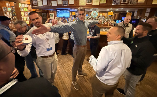 This year's Purdue Raise the Bar event took place off-campus at Harry's Chocolate Shop. Here, Rose Pest Solutions, Mark VanderWerp, BCE, lends his wingspan for "an arms length" of 50/50 raffle tickets. IMAGE: PI CHI OMEGA